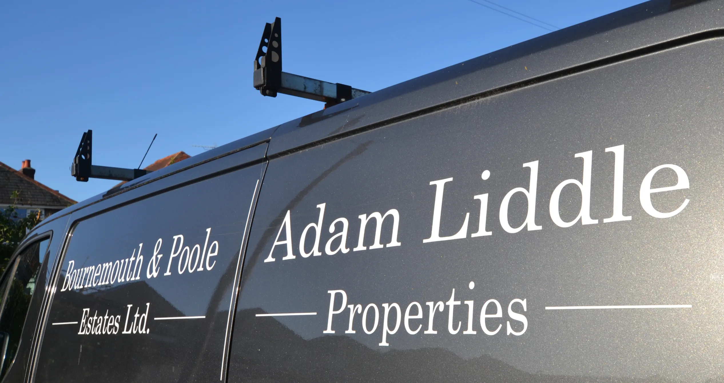 An Adam Liddle Properties maintenance van, lettered with the company name